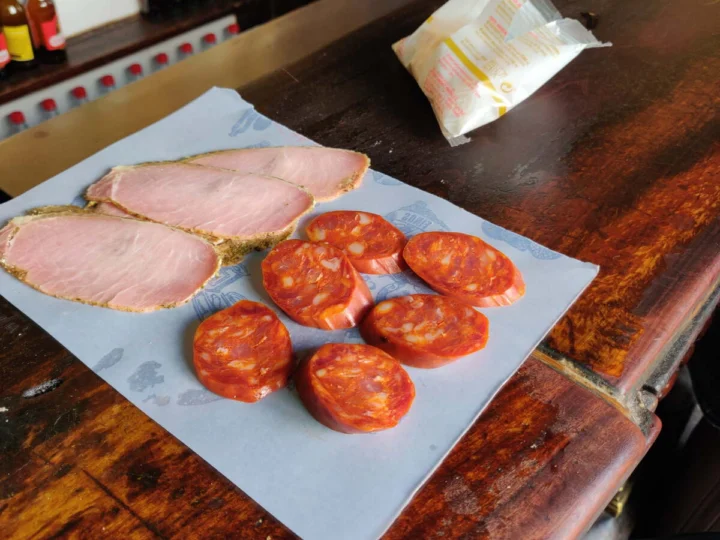 Sliced ham and chorizo on a board on the bar
