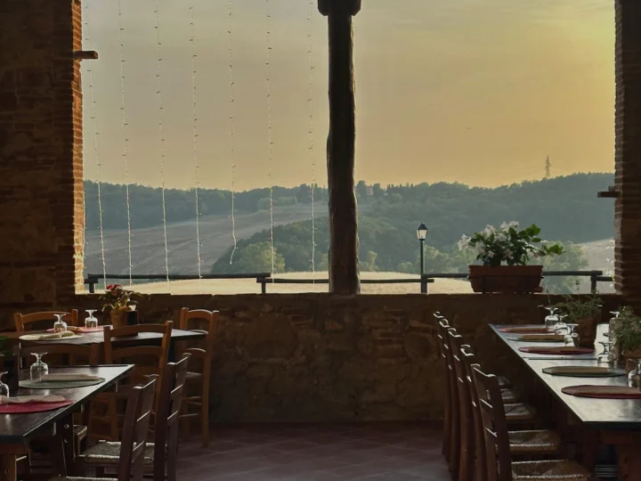 Tables by a wide window at sunset