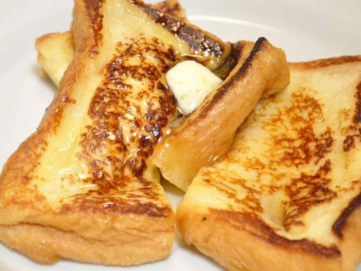 Two slices of golden fried bread with butter