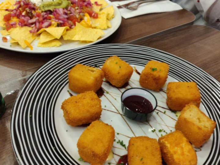 Golden fried croquettes on a striped plate