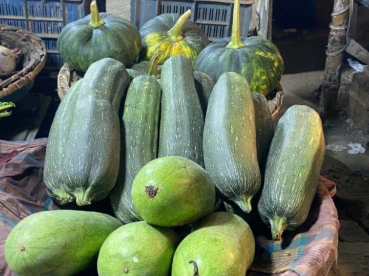 Courgettes and marrows piled on a market stall