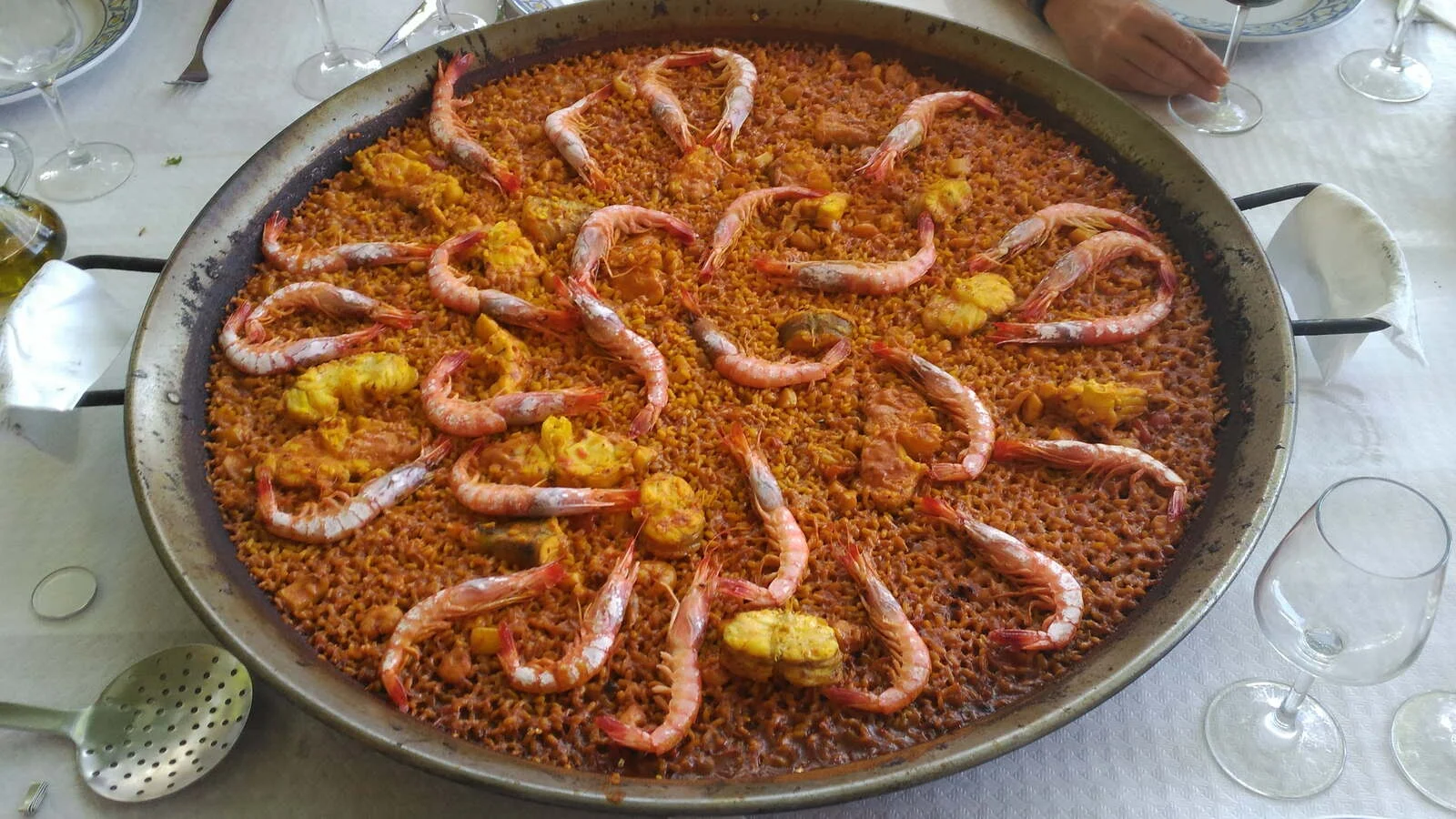 A paella with prawns on a restaurant table