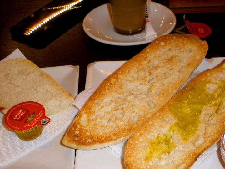 Toasted bread spread with crushed tomato and olive oil