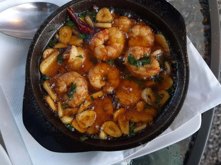 Prawns in a garlic and chilli sauce in a cast-iron dish