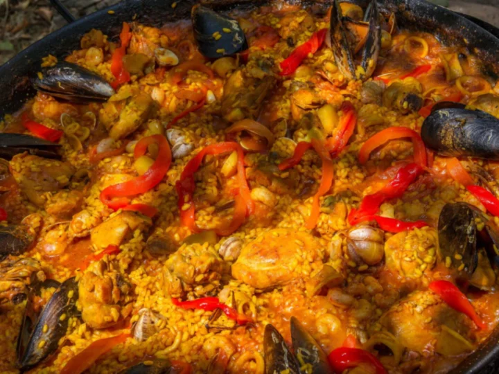 A seafood paella with mussels and red peppers, close up