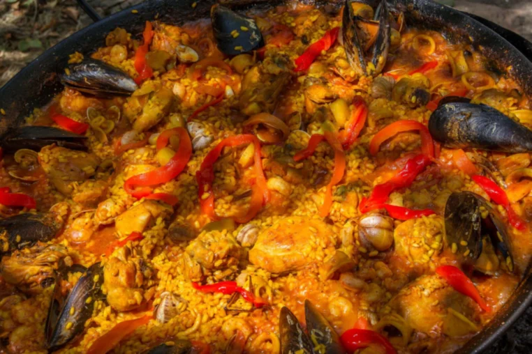 A seafood paella with mussels and red peppers, close up